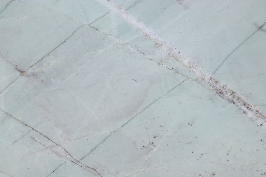 Aquamare — close view of the stone surface. Very pale grey-blue with soft diagonal movement.