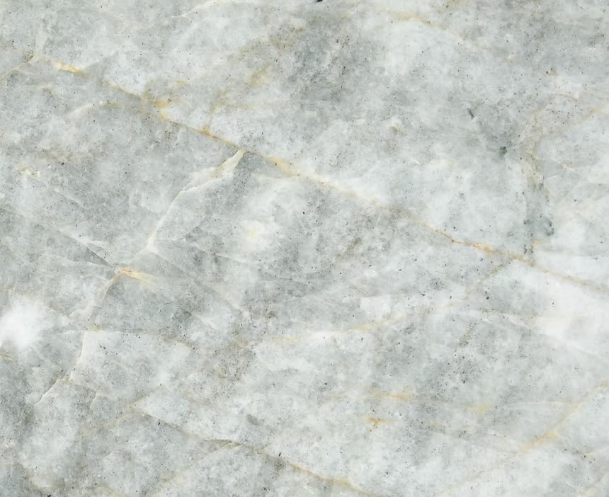 Verde Crystallo — close view of the stone surface. Pale green-white stone with fine amber threads.